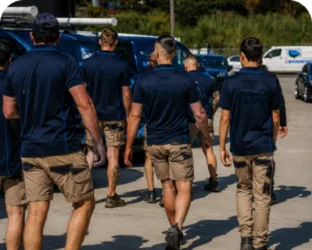 Plumbers walking to their service vans on a Cronulla job